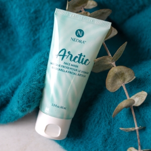 Image of Arctic Gel Face Mask on top of a blue towel and a eucalyptus branch.